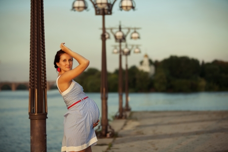 Pregnant caucasian woman takes rest outdoorの写真素材