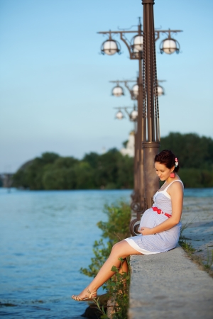 Pregnant caucasian woman takes rest outdoorの写真素材