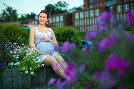 Pregnant caucasian woman takes rest outdoorの写真素材