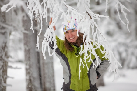Young woman posing at camera in winter mountainsの写真素材
