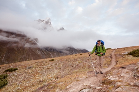 Hiker posing at camera on the trek in Himalayas, Nepalの写真素材