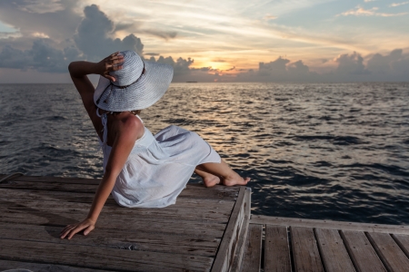 Caucasian woman rests at beautiful seashoreの写真素材