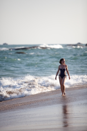Woman takes rest at the sea shoreの写真素材