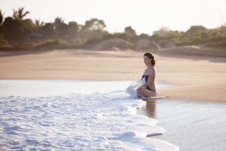 Woman takes rest at the sea shoreの写真素材