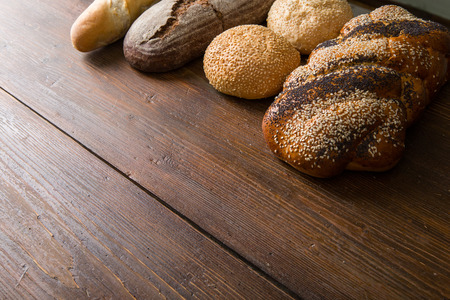 Fresh baked bread at wooden tableの写真素材