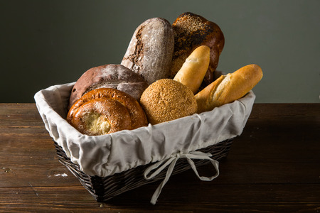 Photo of the assorted bread in wooden basketの写真素材