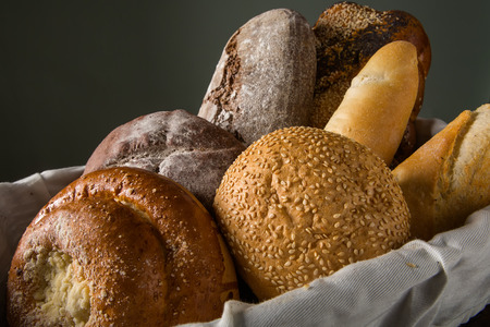 Photo of the assorted bread in wooden basketの写真素材