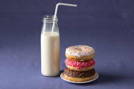 Donut with milk at violet backgroundの写真素材
