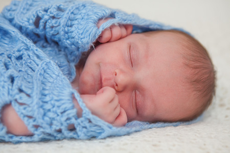 Caucasian newborn baby while sleeping closeupの写真素材