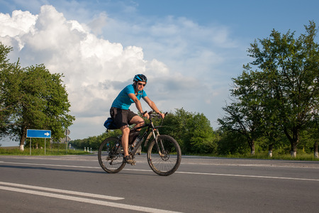 Man cycling at the roadの写真素材