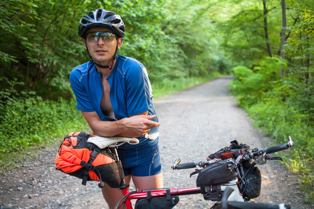 Portrait of mtb cyclist at forest road in summertime