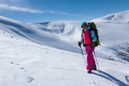 Hiker in winter mountains on sunny dayの写真素材