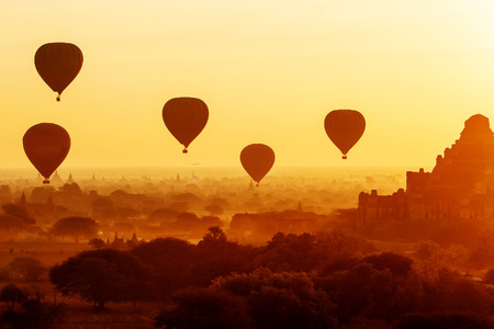 air balloons over Buddhist temples at sunrise. Bagan, Myanmar.の写真素材