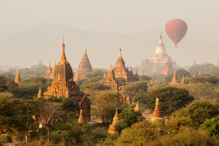 air balloons over Buddhist temples at sunrise. Bagan, Myanmar.の写真素材