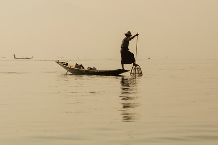 Fisherman in Inle lakes sunset, Myanmar.の写真素材
