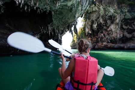 Caucasian woman is kayaking in sea at Thailandの写真素材