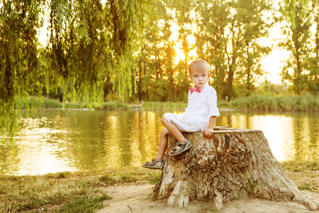 Happy child playing outdoors in autumn parkの写真素材