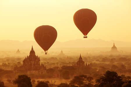 air balloons over Buddhist temples at sunrise. Bagan, Myanmar.の写真素材