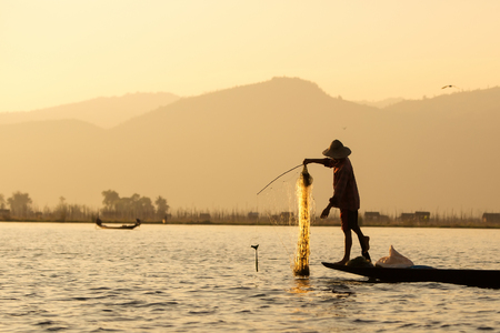 Fishermen in Inle lakes sunset, Myanmar.の写真素材
