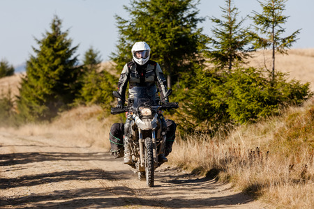 Motorbiker travelling in autumn mountainsの写真素材