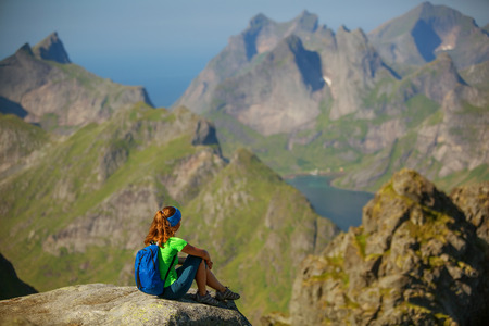 Woman takes rest on top of mountain in Norwayの写真素材