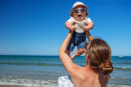 Family has fun at the seashore in summertime