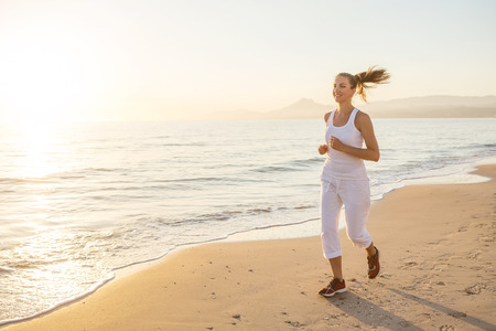 Caucasian woman jogging at seashoreの写真素材