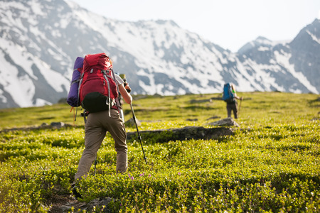 Young people are hiking in highlands of Altai mountains, Russiaの写真素材
