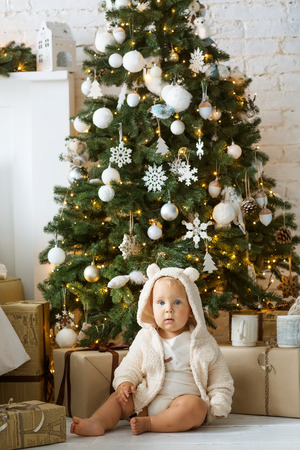 Happy boy playing near Christmas treeの写真素材