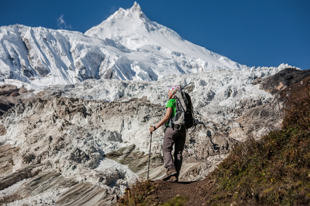 Trekker in front of Manaslu glacier on Manaslu circuit trek in Nepalの写真素材
