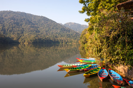 Colorful boats in Phewa lake in Pokhara, Nepalの写真素材