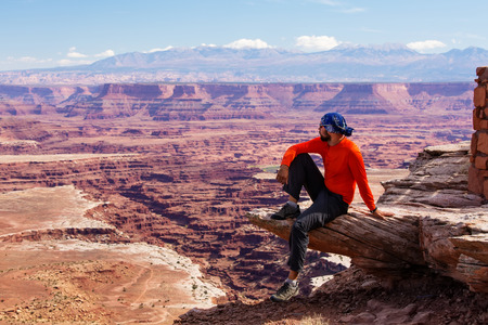 Hiker rests in Canyonlands National park in Utah, USAの写真素材