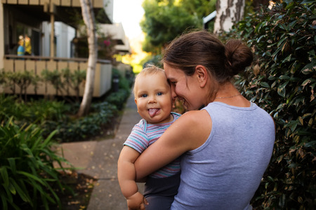 A mother with baby son in green neighborhoodの写真素材