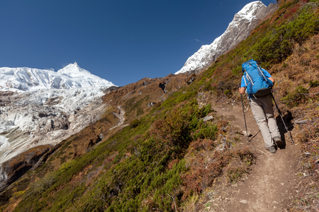 Hiker is climbig to Manaslu base camp in highlands of Himalayas on Manaslu circuitの写真素材