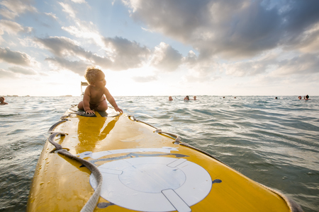kid have fun on surfboard in the oceanの写真素材