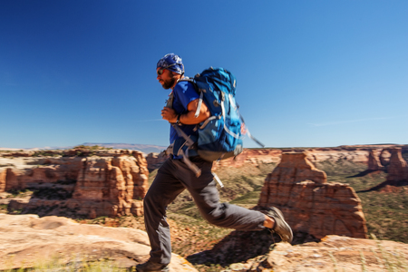 Hiker is sitting on the cliff in Colorado National monument, USA