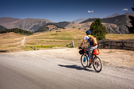 Mountain biker is travelling in the highlands of Tusheti region, Georgiaの写真素材