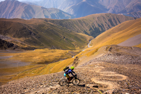 Mountain biker is travelling in the highlands of Tusheti region, Georgiaの写真素材