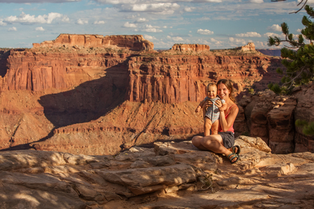 A mother and her baby son visit Canyonlands National park in Utah, USAの写真素材