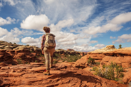 Hiker in Canyonlands National park, needles in the sky, in Utah, USAの写真素材