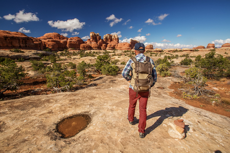 Hiker in Canyonlands National park, needles in the sky, in Utah, USAの写真素材