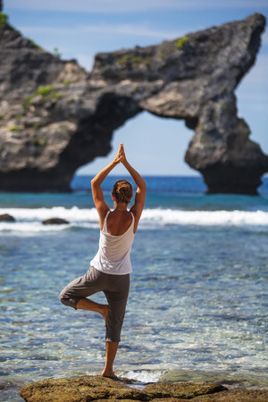 Caucasian woman practicing yoga at seashoreの写真素材