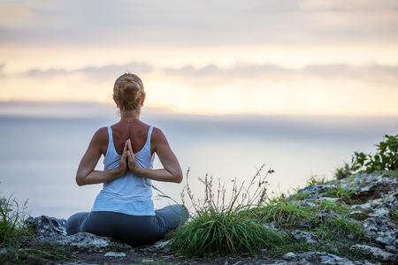 Caucasian woman practicing yoga at seashoreの写真素材