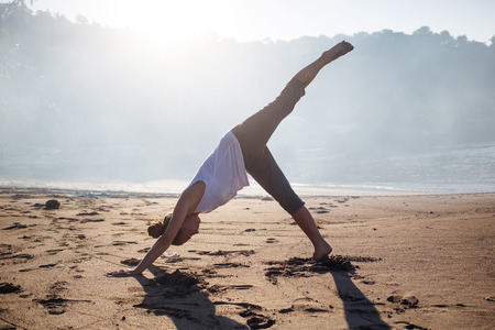 Caucasian woman practicing yoga at seashoreの写真素材
