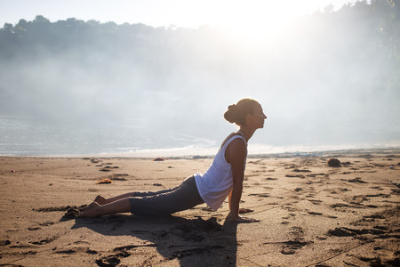 Caucasian woman practicing yoga at seashoreの写真素材