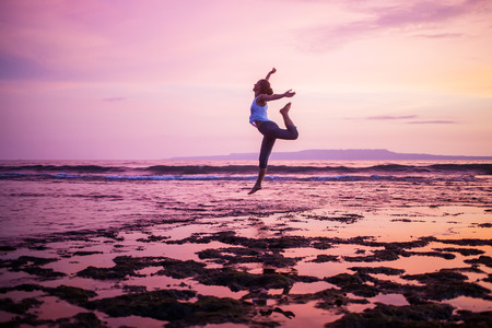 Caucasian woman practicing yoga at seashoreの写真素材