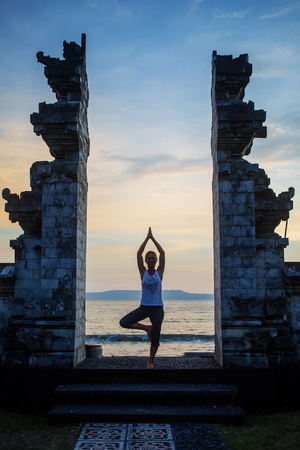 Caucasian woman practicing yoga at seashoreの写真素材