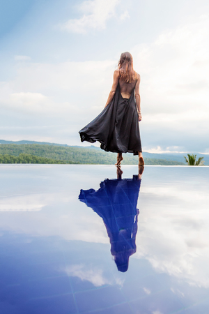 Beautiful woman by the poolの写真素材
