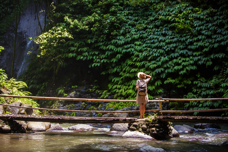 Woman near Nung Nung waterfal on Bali, Indonesiaの写真素材