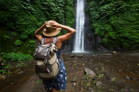 Woman near Munduk waterfal on Bali, Indonesiaの写真素材